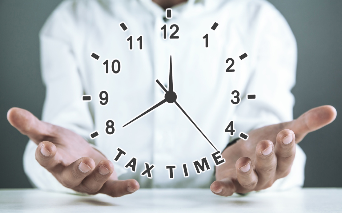 Man holding clock. Tax time